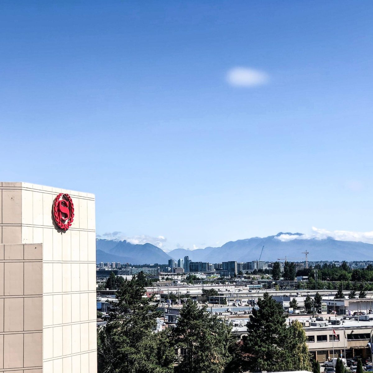 Sheraton Hotel logo in Richmond, BC with mountain view located in a city